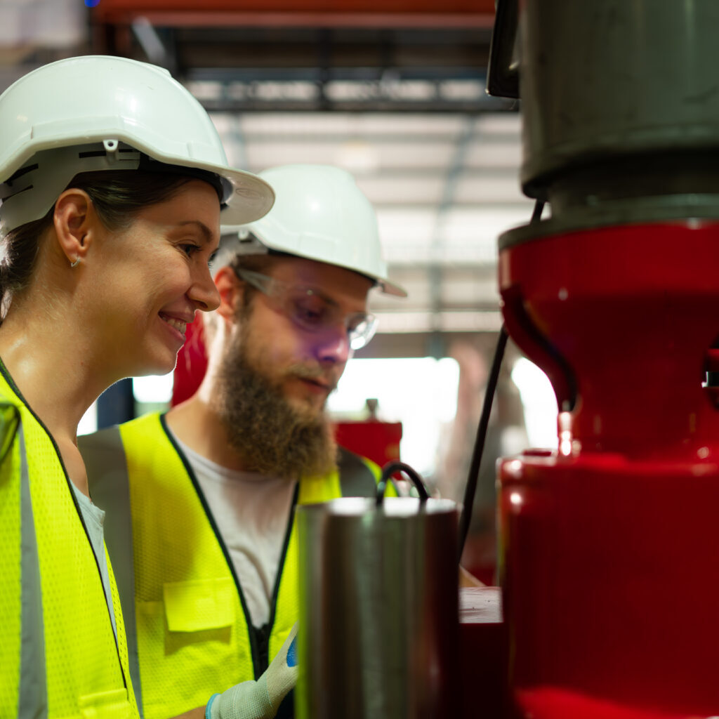 Both of mechanical engineers are checking the working condition Both of mechanical engineers are checking the working condition of the new machine after completing the installation